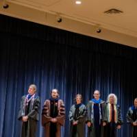 Faculty waiting on stage